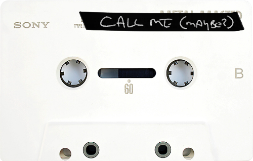 Auto-generated description: A white cassette tape labeled CALL ME (MAYBE?) with handwritten text on black tape is displayed.