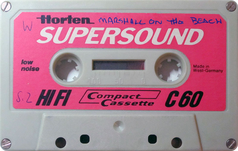 Auto-generated description: A vintage Horten Supersound C60 compact cassette with handwritten text Marshall on the Beach is displayed.